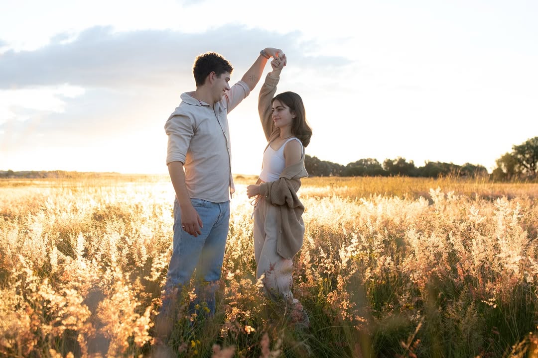 Couple walking hand-in-hand at sunset