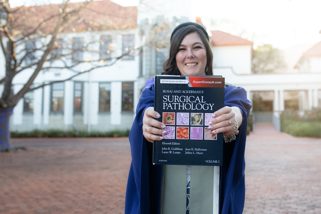 Formal graduation portrait with diploma