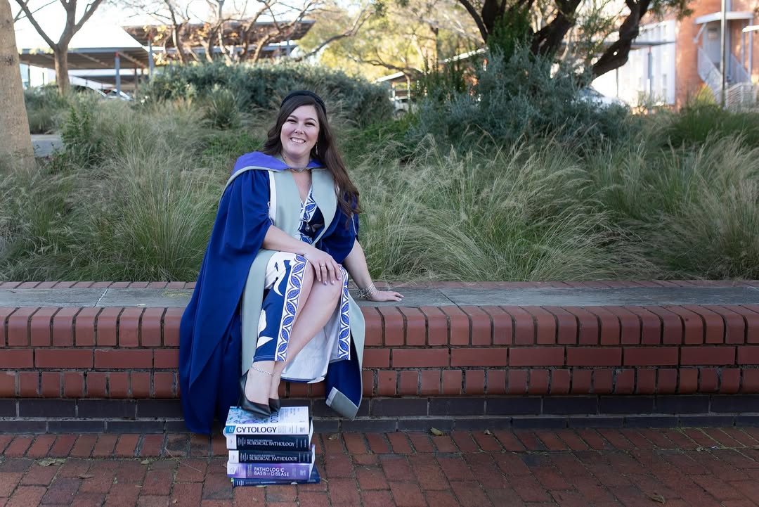 Group graduation photo with friends on campus